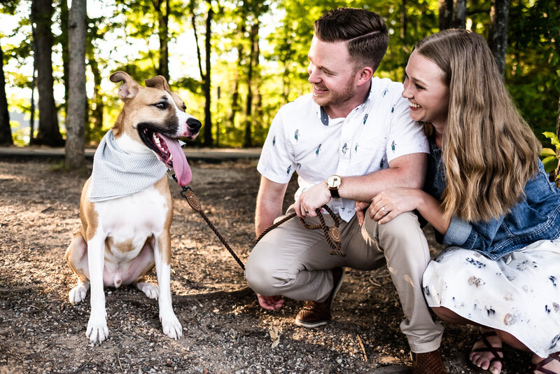 Luxury Portraits by Moving Mountains Photography in NC - Photo of a couple smiling at their dog.