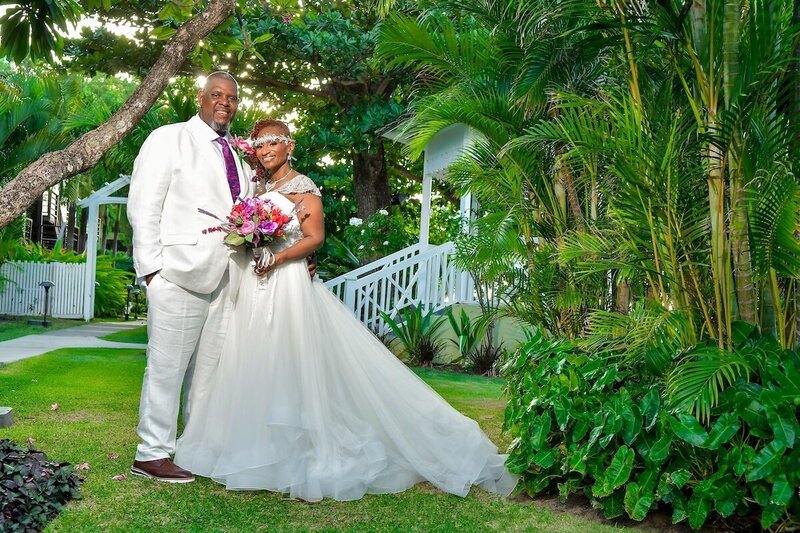 Bride and groom pose in front of greenery in St. Lucia