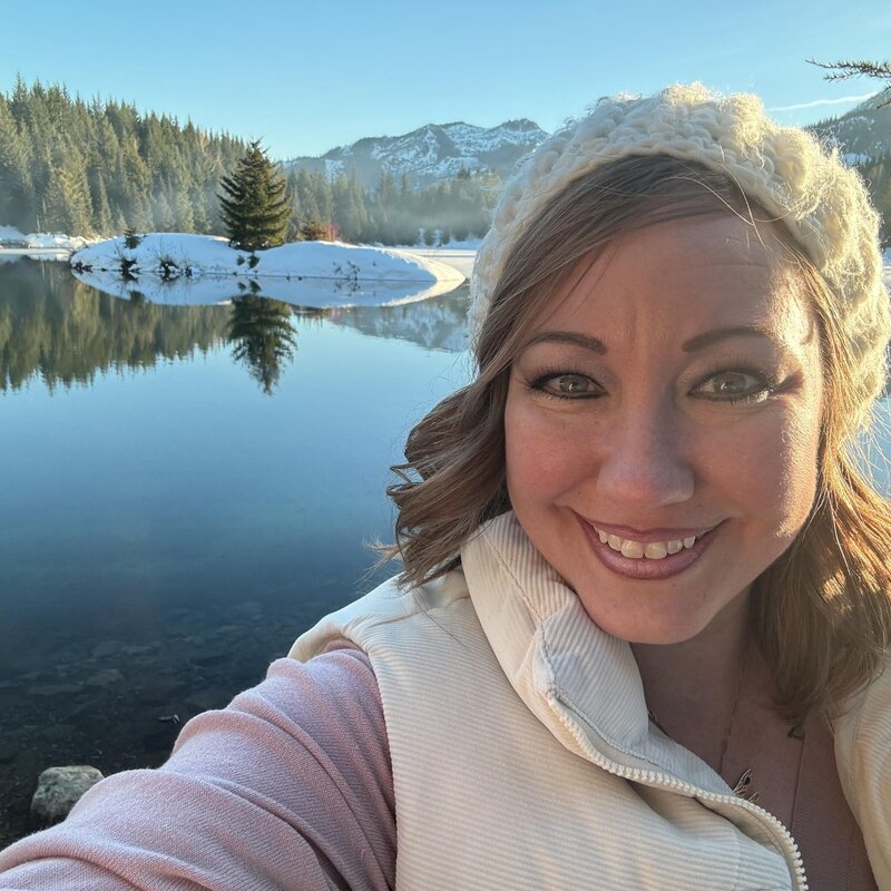 Women standing in front of lake
