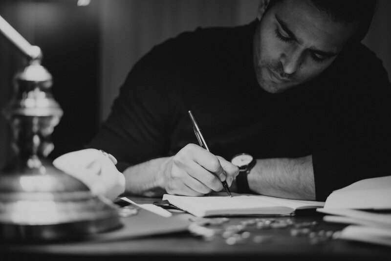 man writing in journal