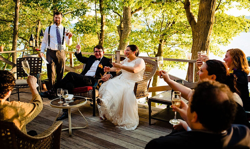 bride and groom cheers on deck with family and friends