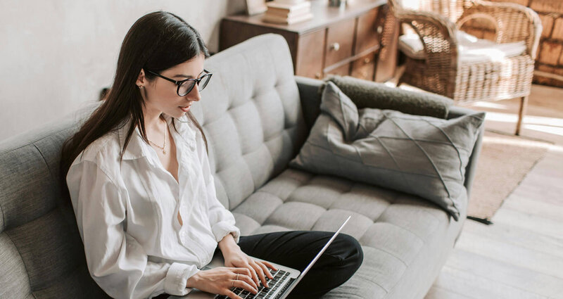 Woman with glasses looking at her computer