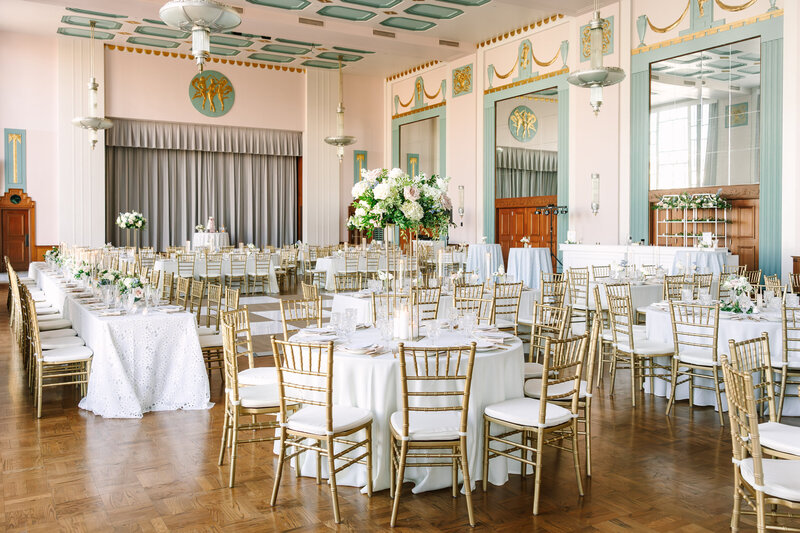 Elegant Oklahoma ballroom wedding reception with gold chairs, white linens, and refined floral centerpieces designed by Harper Mae Events