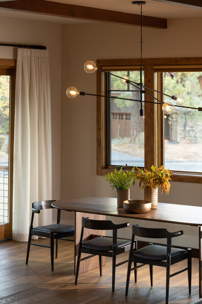Interior design photography of a modern dining room with wooden table and unique lighting.