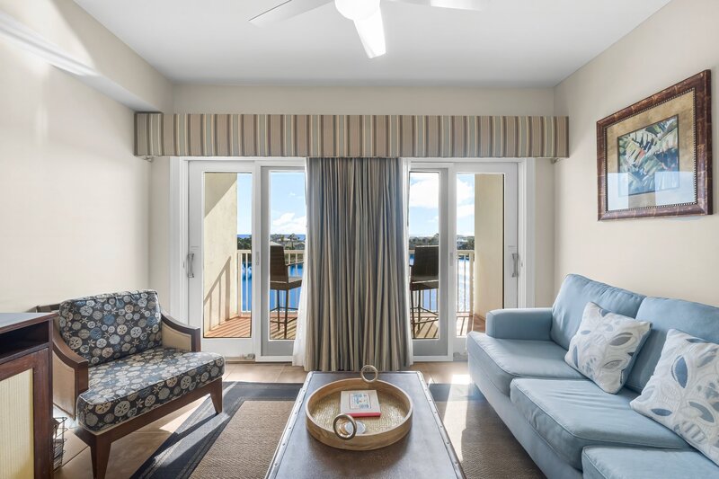 living room with blue couch and beach themed arm chair