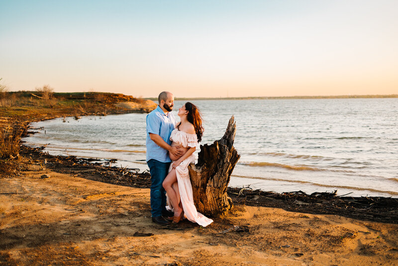 The warmth of family moments in this spring maternity photo featuring a pregnant woman in a long orange dress