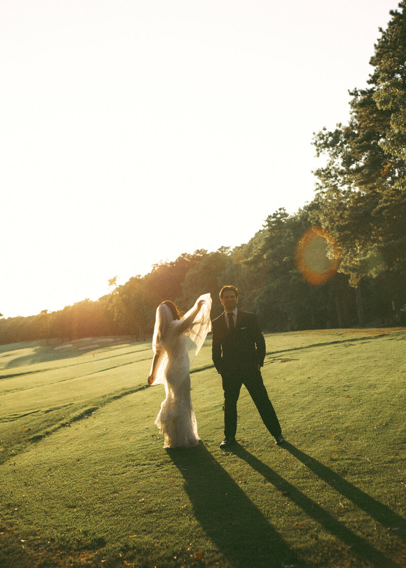 Bride and groom running through field – documentary wedding photographer Charleston SC