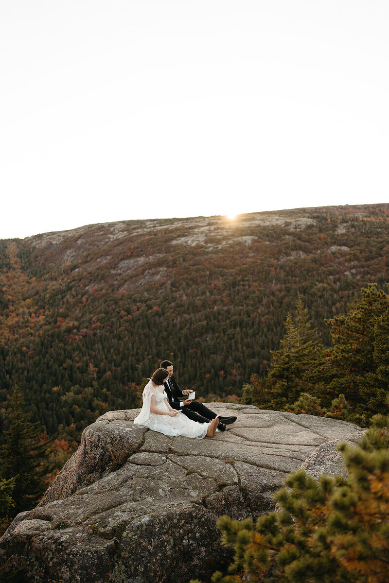 A couple reads their vows in Acadia National Park at North Bubble. Acadia elopement inspiration. Sunset vow locations in Acadia. 