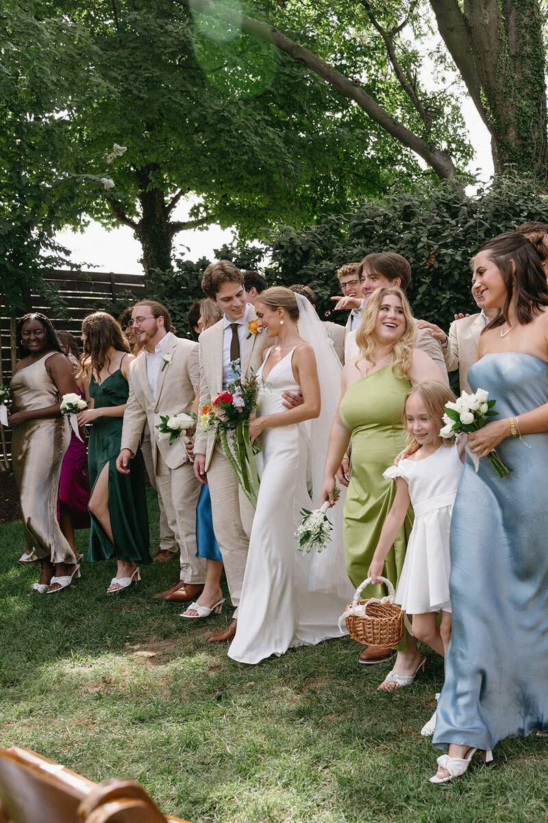 Bride and groom are in their own world as they take bridal party photos but focus on each other.