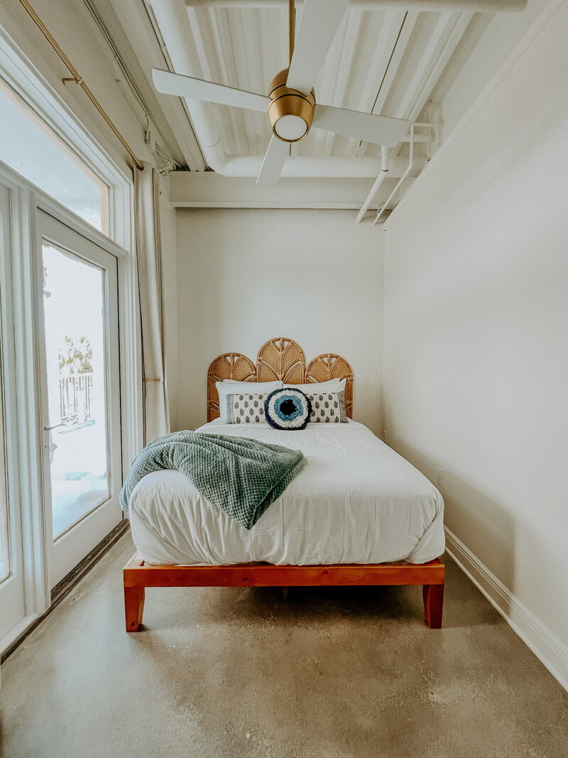 white bed with a rattan frame