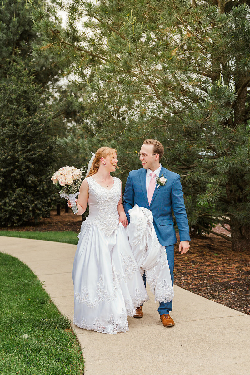 husband and wife walking together smiling after their wedding by york and lancaster pa photographer