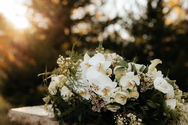 Wedding bouquet sitting on a pedestal.