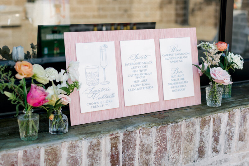 Champagne glasses sitting on a display with a blue and orange monogram decoration