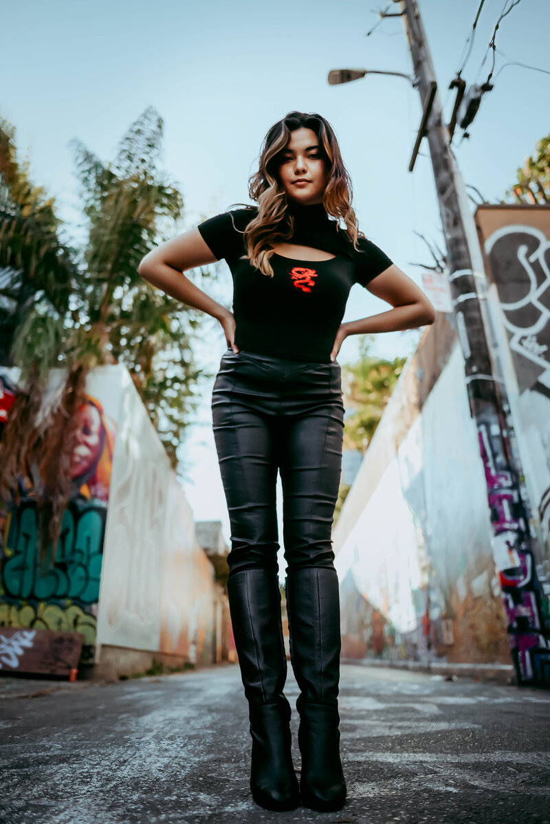 woman posing outside in an alley