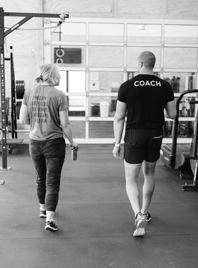 A Skopos Athletics coach working one-on-one with a gym member during a personal training session in Dundas, MN.