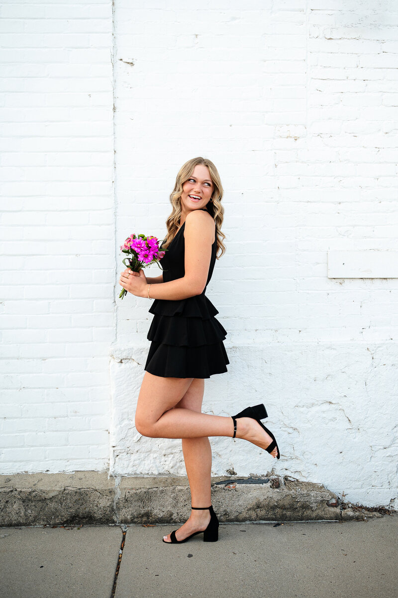Onsite High School Graduation Photos NW Ohio near Toledo with graduate holding flowers