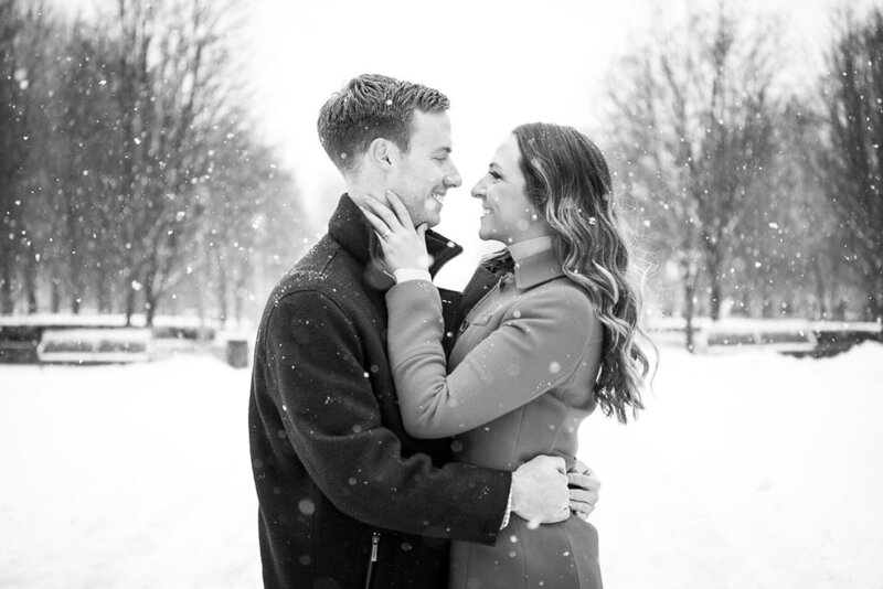 couple kiss during downtown detroit snowy winter engagement session
