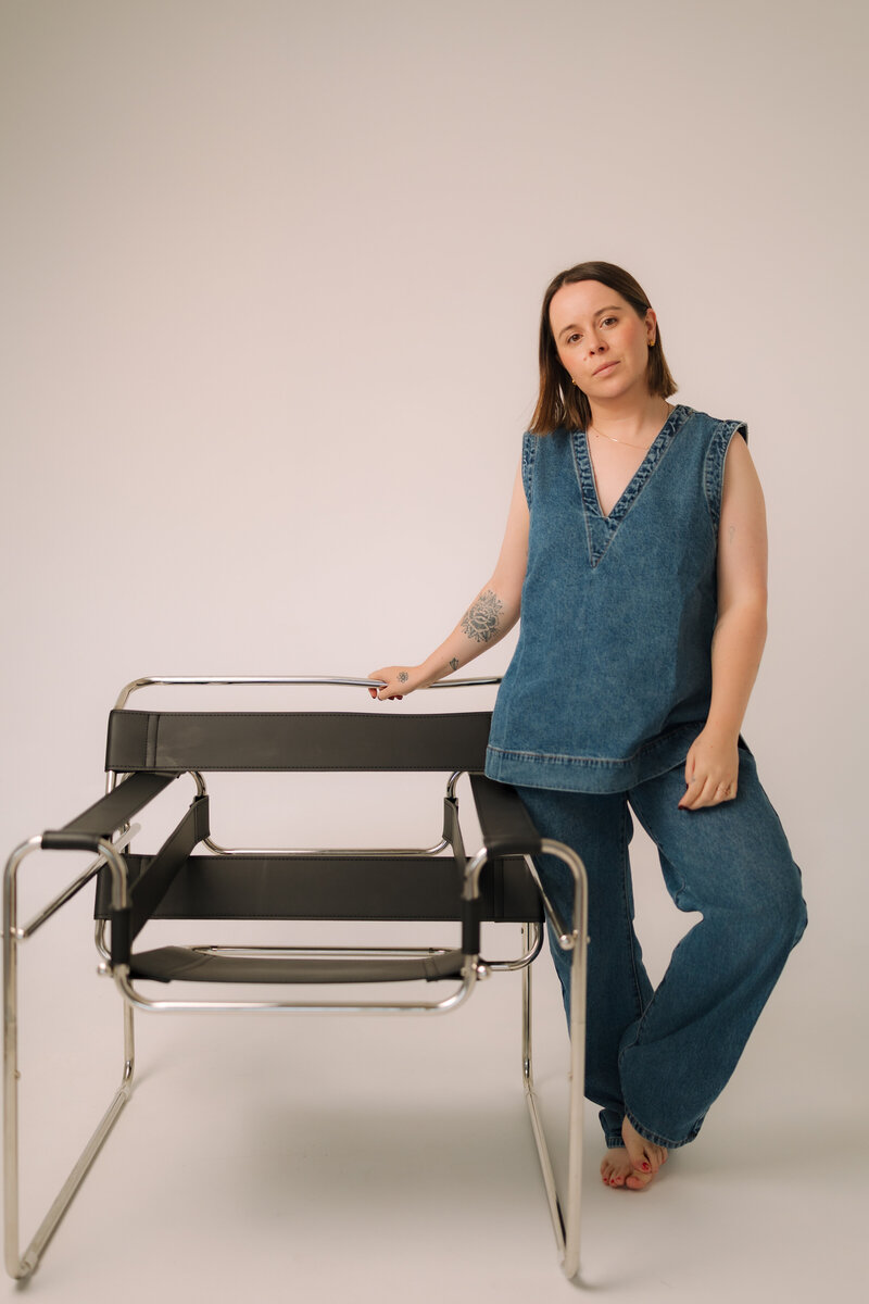 Liv Rollings standing by chair in studio