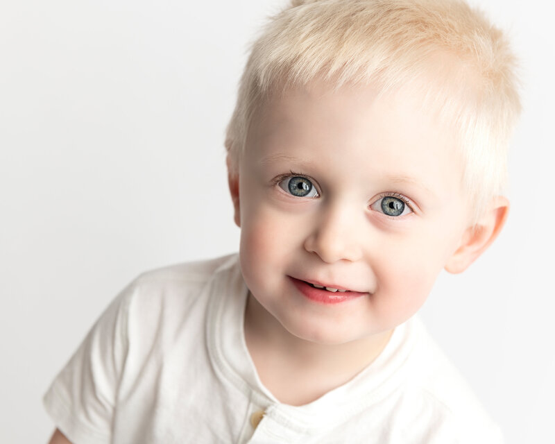 Captured in a bright and simple setup, this toddler milestone portrait radiates happiness and the charm of early childhood.