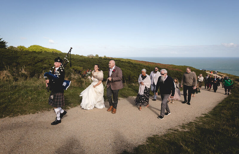 Bride and groom walking at Howth Cliff Walk for their micro wedding  in Dublin, Ireland