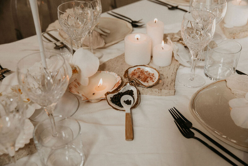 neutral, tan tablescape with candles lit at the center