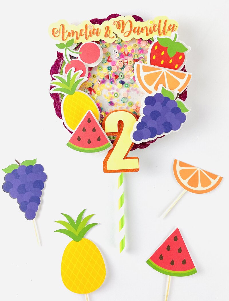 Bright and colorful Tutti Fruiti cake topper with watermelon, pineapple, grapes
