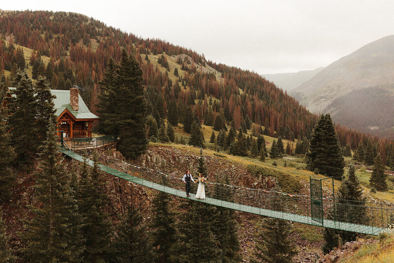 bride and groom walking on bridge