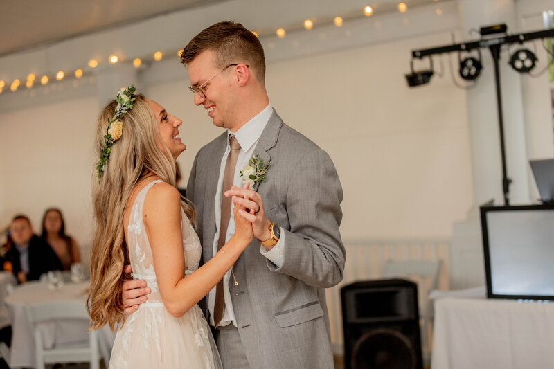 bride and groom smiling while dancing