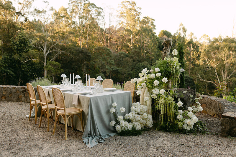 Woman  setting up table with flowers and candles