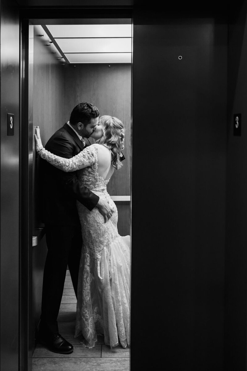 Couple kiss in elevator at Loft Lucia in Chicago.