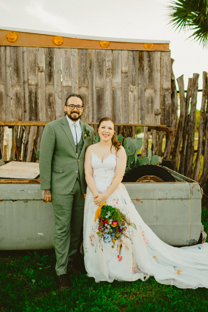 Happy couple at San Antonio wedding venue with cactus.