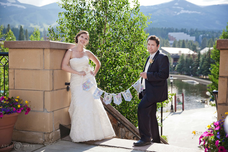 Wedding couple pose for a portrait outside on the patio at their Main Street Station wedding reception in Breckenridge during summer