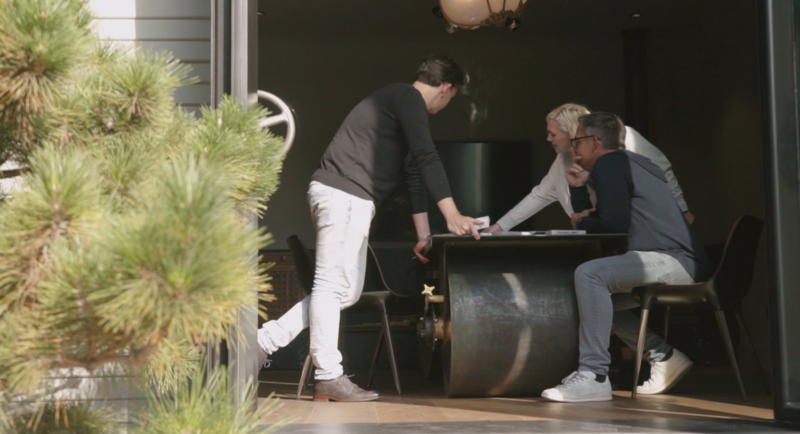 Los Angeles architect working around a table with other team members