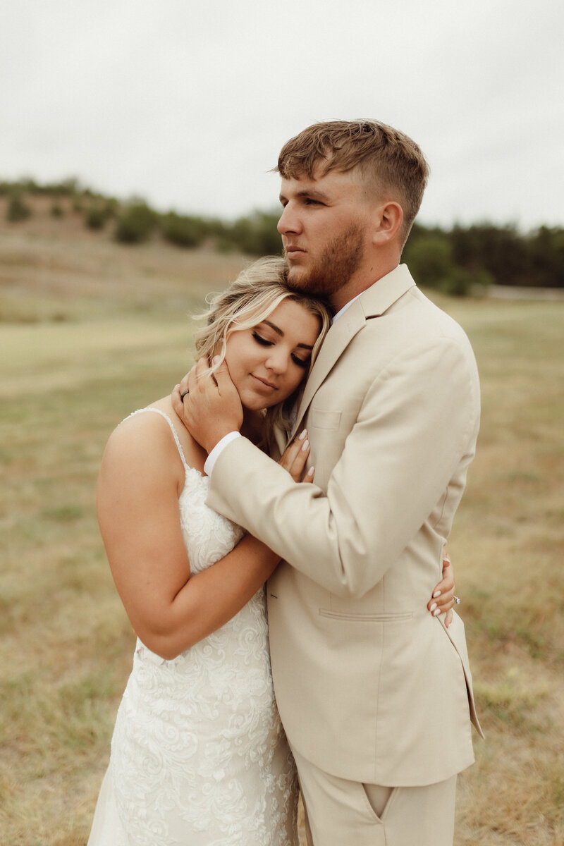 bride and groom| Wedding photos| wedding photographer cost average|Bride and groom together in field for bridal photos.