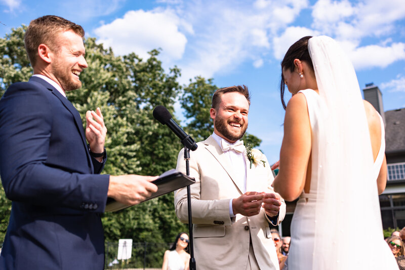 A groom laughing at the wedding ceremony in Toledo Ohio