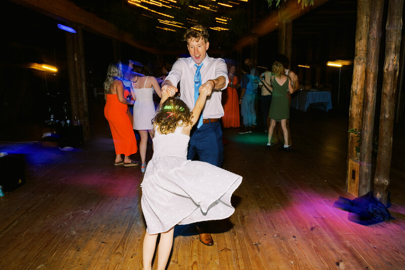 The groom dances with the flower girl during the barn reception at Paint Rock Farm in North Carolina, by My Sun and Stars Co.