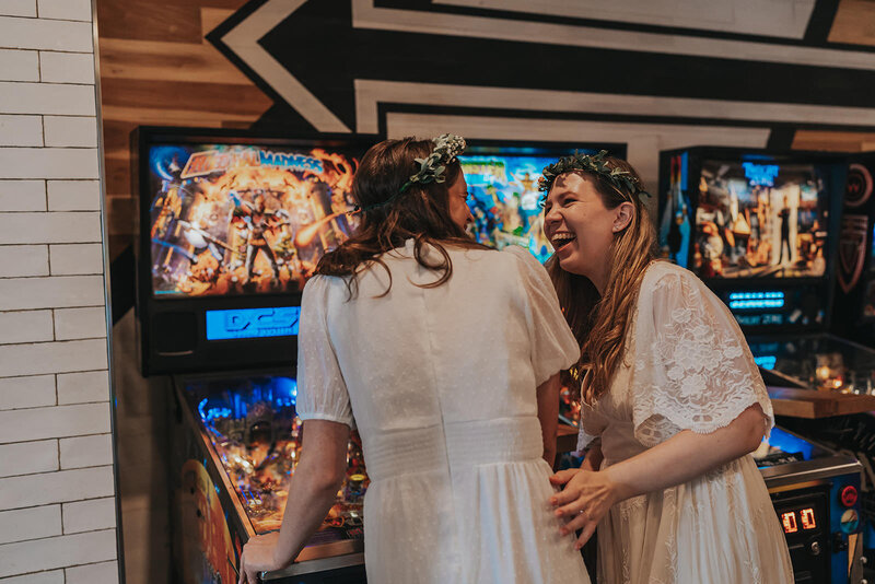 Two women giggle in a Nashville arcade