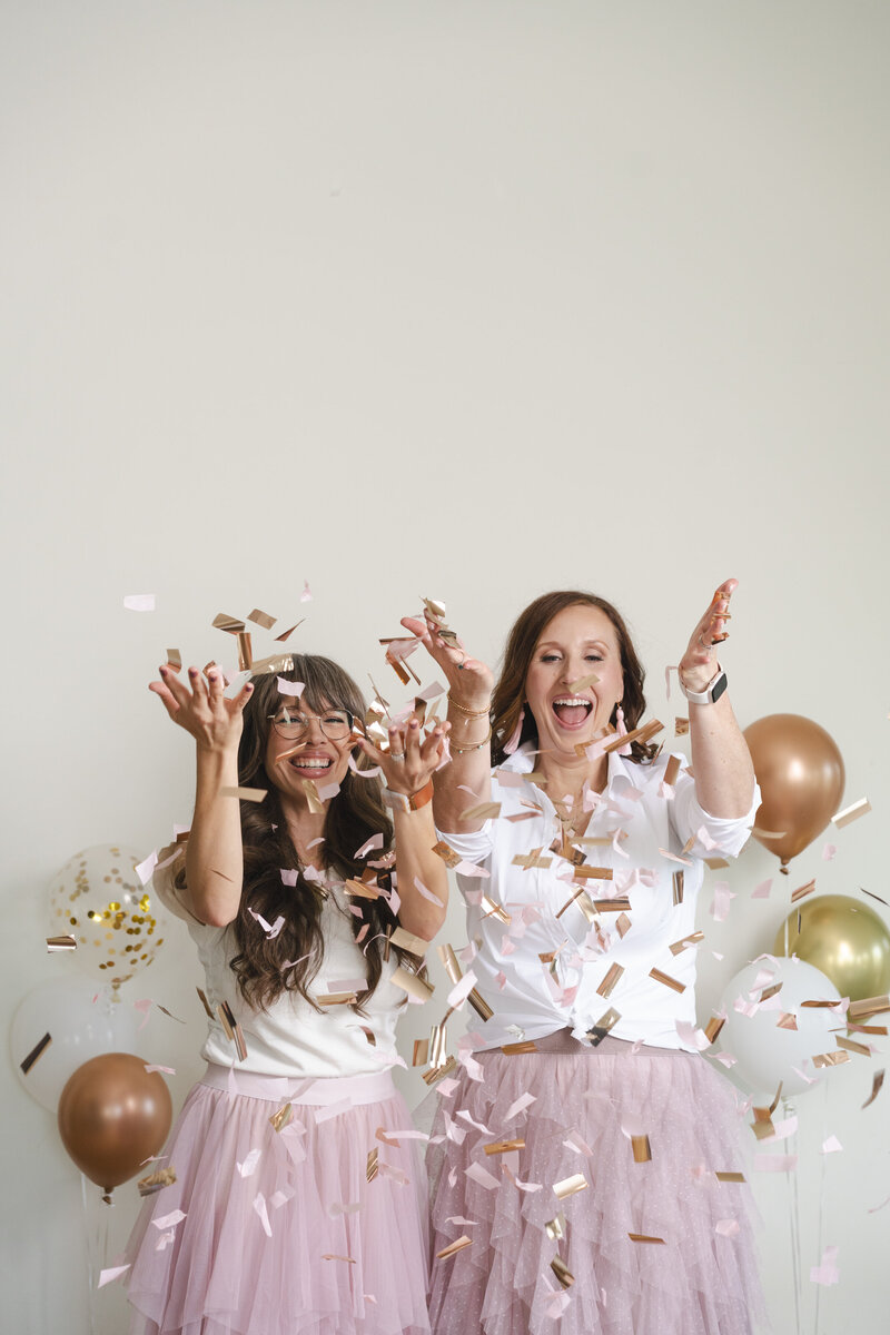 women-business-owners-celebrating-with-balloons-and-confetti