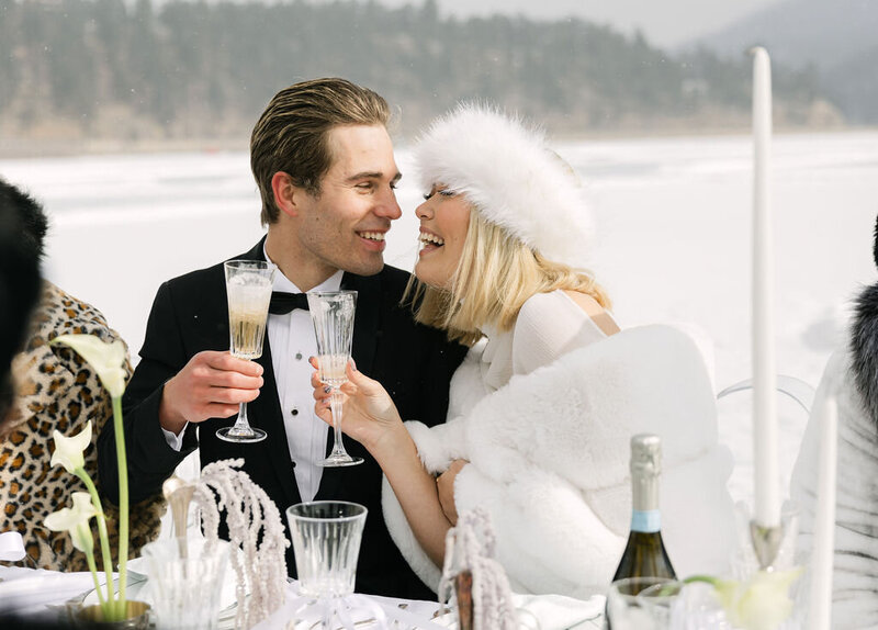 bride and groom cheersing at their outdoor luxury winter wedding reception in Colorado 
