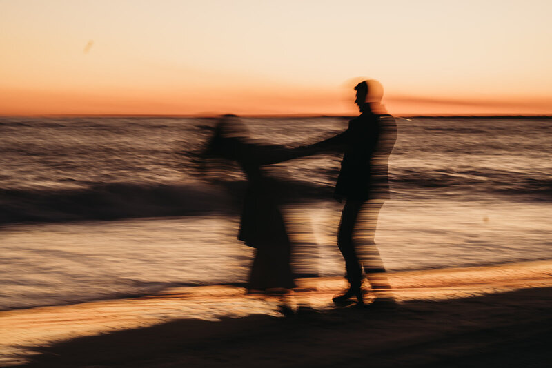 Couple spins on the beach in NC, North Carolina - celebrating their engagement