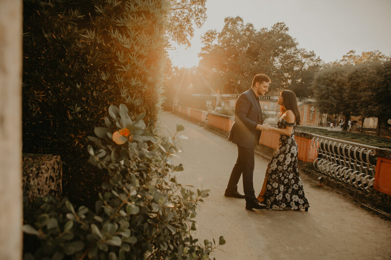 A couple playing as they take engagement photo at Vizcaya Museum & Gardens in Miami Florida.