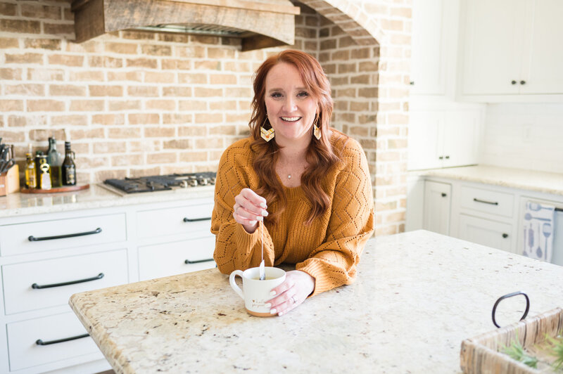 Ashleigh Foy, Systems and Efficiency Coach for Faith-Led Solopreneurs, smiling and standing confidently in a light-filled workspace