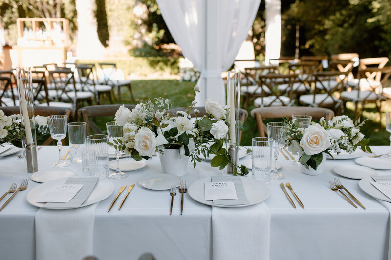 3-radiant-love-event-2021-outdoor-seating-white-seating-greenery-white-flowers-gold-cutlery-romantic-elegant-timeless