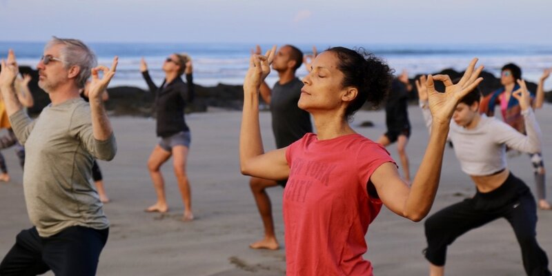 Yoga Teacher Trainee's practice mudra in yoga class on the beach in Costa Rica