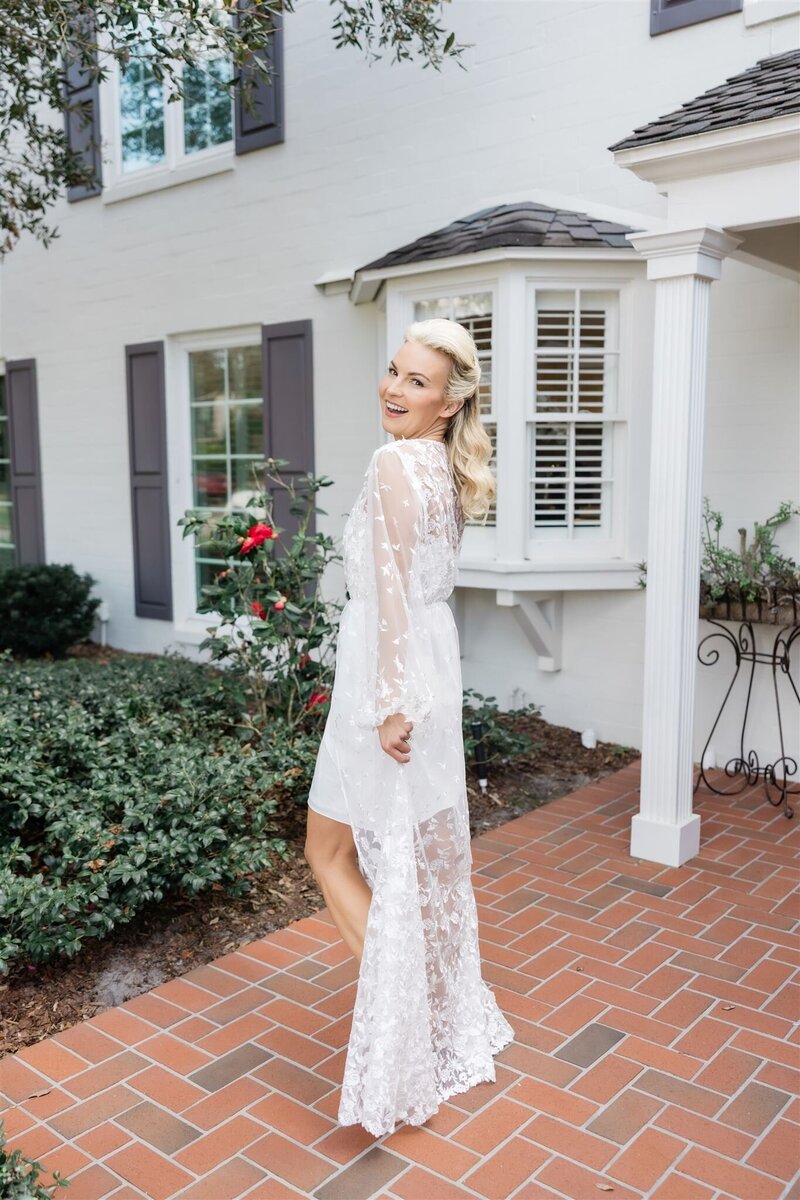 A bride in her wedding robe by Orlando wedding photographer. 