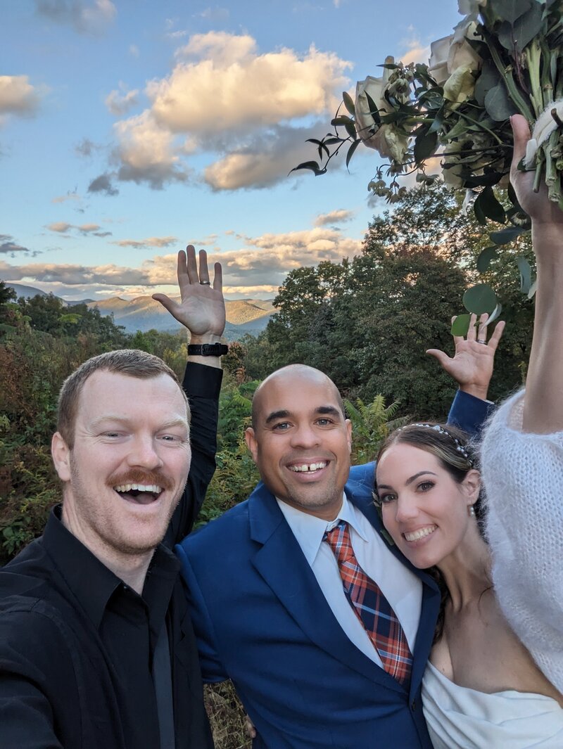 Couple poses for a selfie with their wedding photographer after their elopement