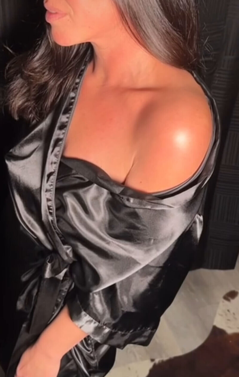 Close-up of client after rapid spray tan application at Boho Glow Studio in Mankato, MN, with a bronzed, glowing finish.