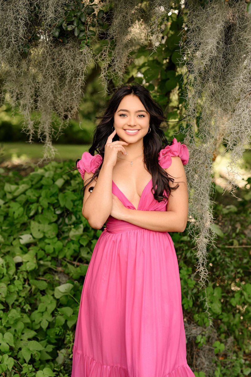 with the spanish moss around her this waxhaw grad poses in a bright pink dress in charleston, sc