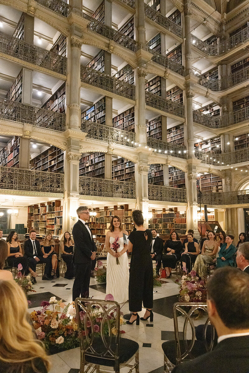 Bride and groom wedding ceremony inside the George Peabody Library