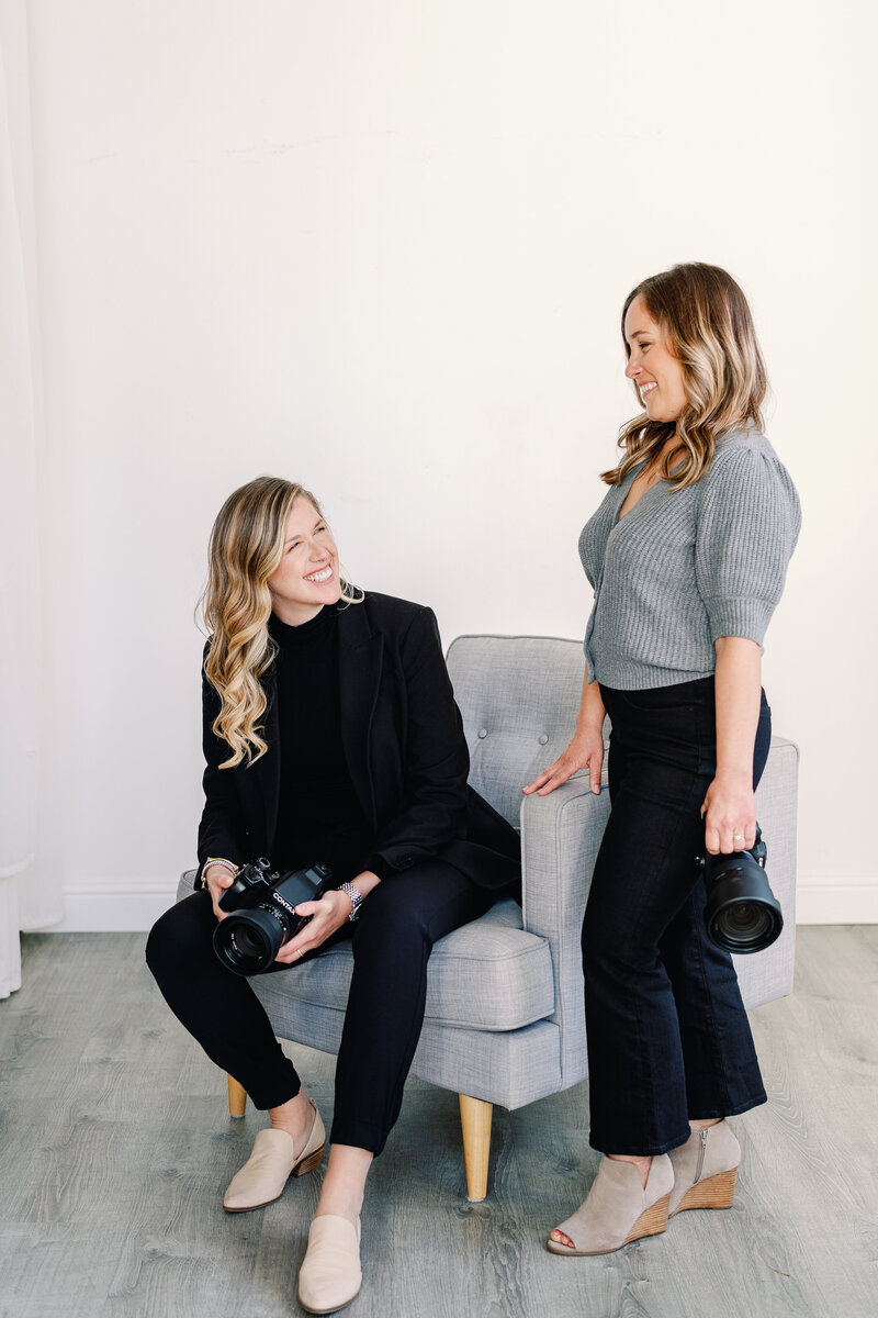 two women holding cameras